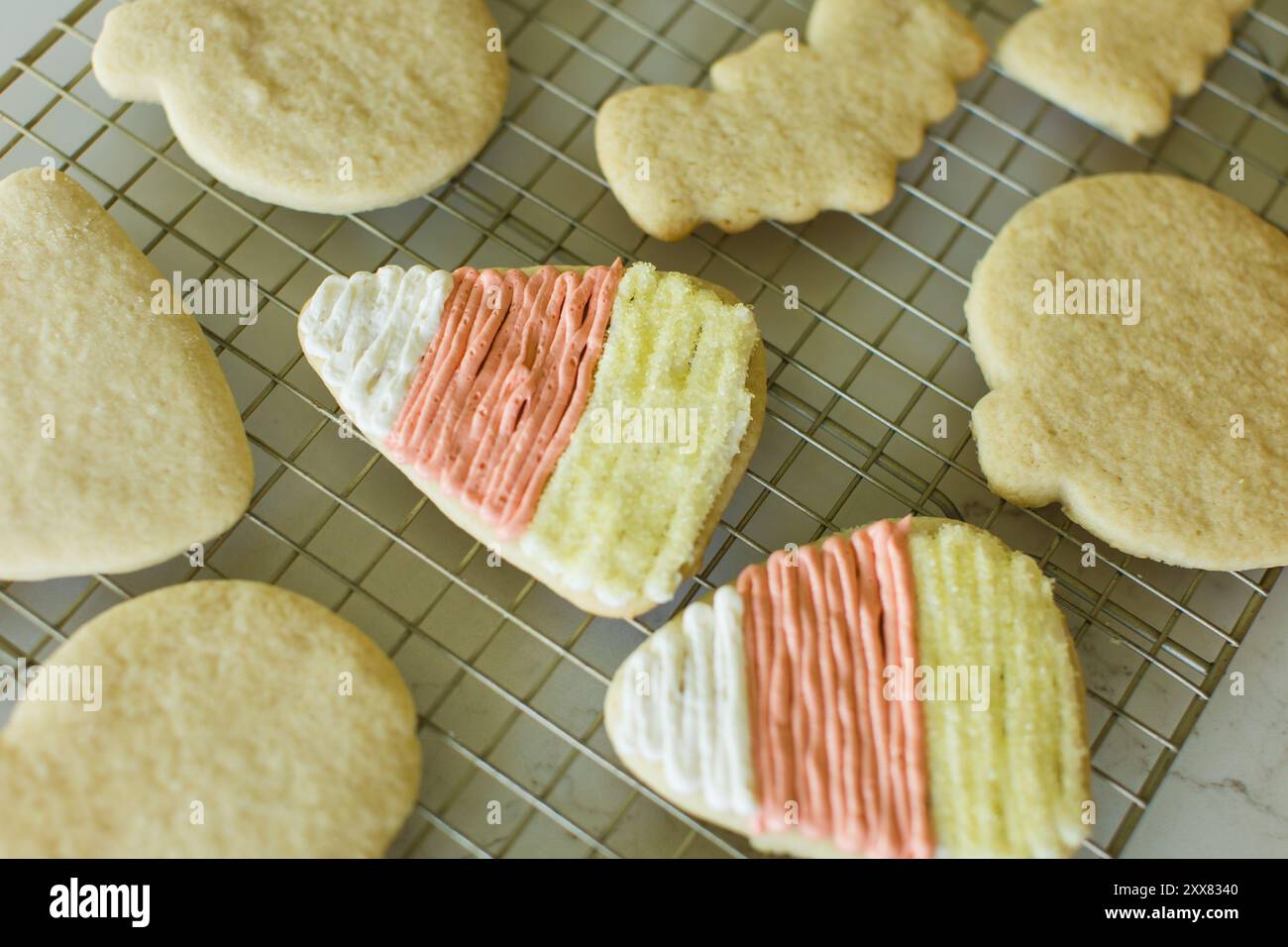 Frosted Halloween cookies on cooling rack, candy corn Stock Photo