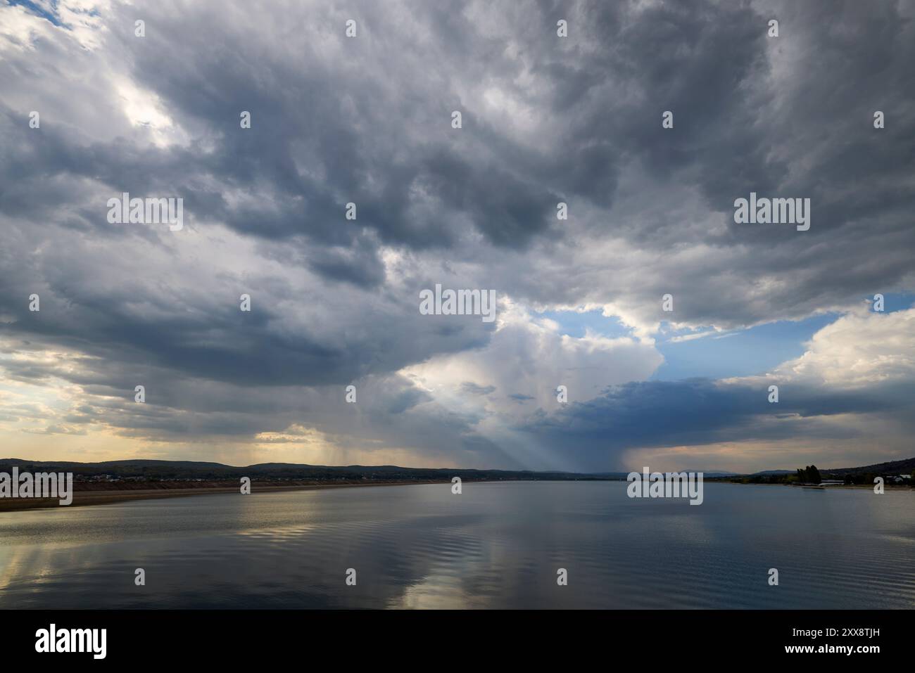 landscape with rain clouds above a lake Stock Photo - Alamy