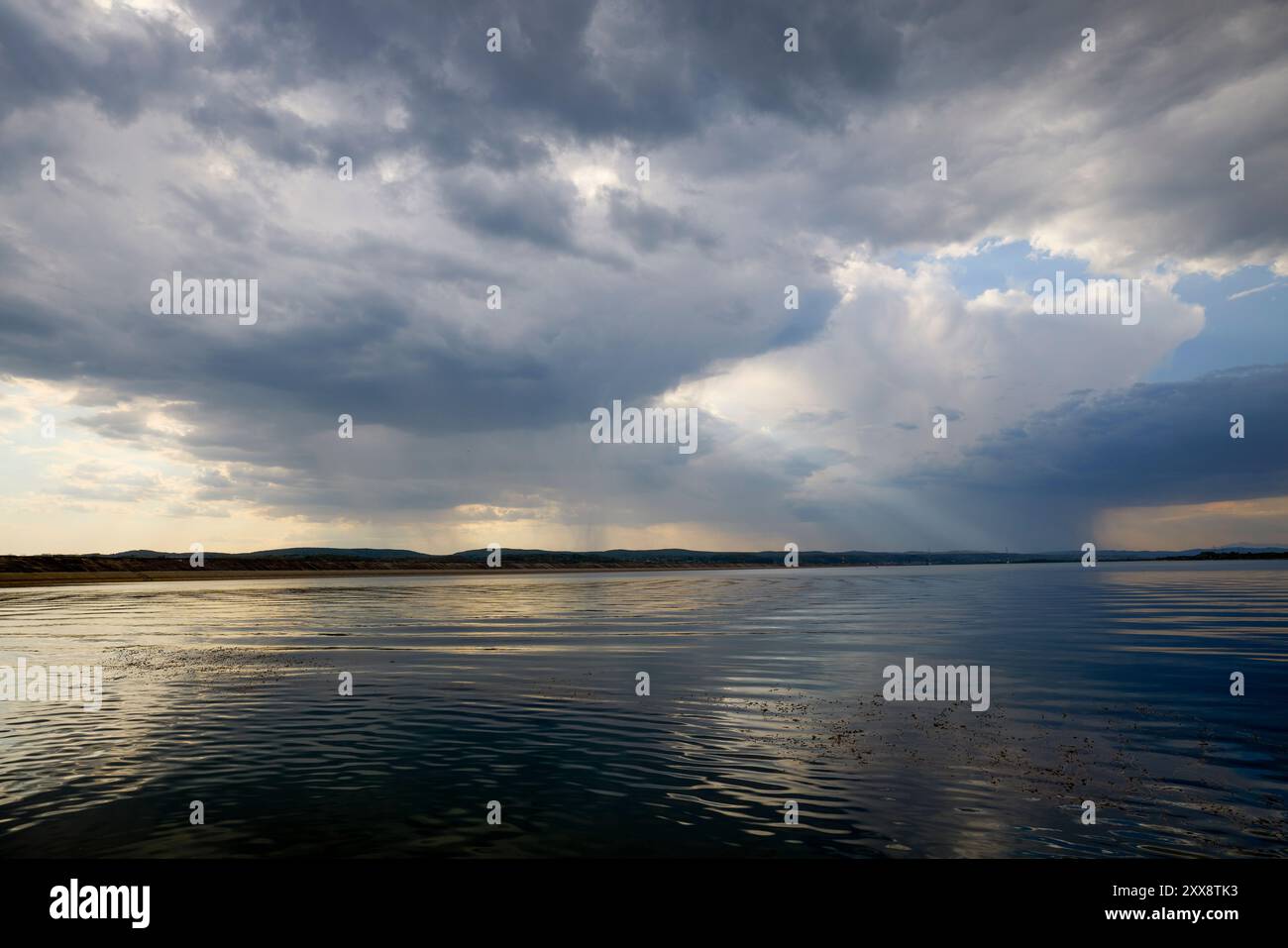 landscape with rain clouds above a lake Stock Photo - Alamy