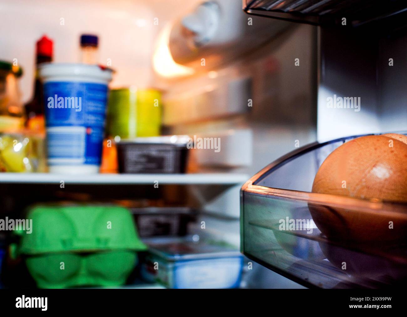 View into an illuminated refrigerator filled with food Stock Photo