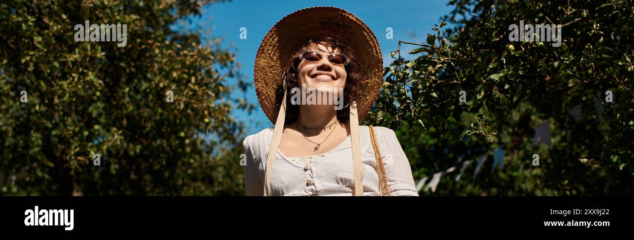 Woman wearing straw hat walks hi-res stock photography and images - Alamy