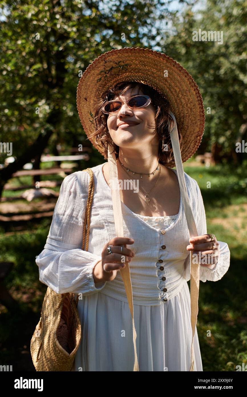 A young woman with dark hair wears a white blouse and a straw hat ...