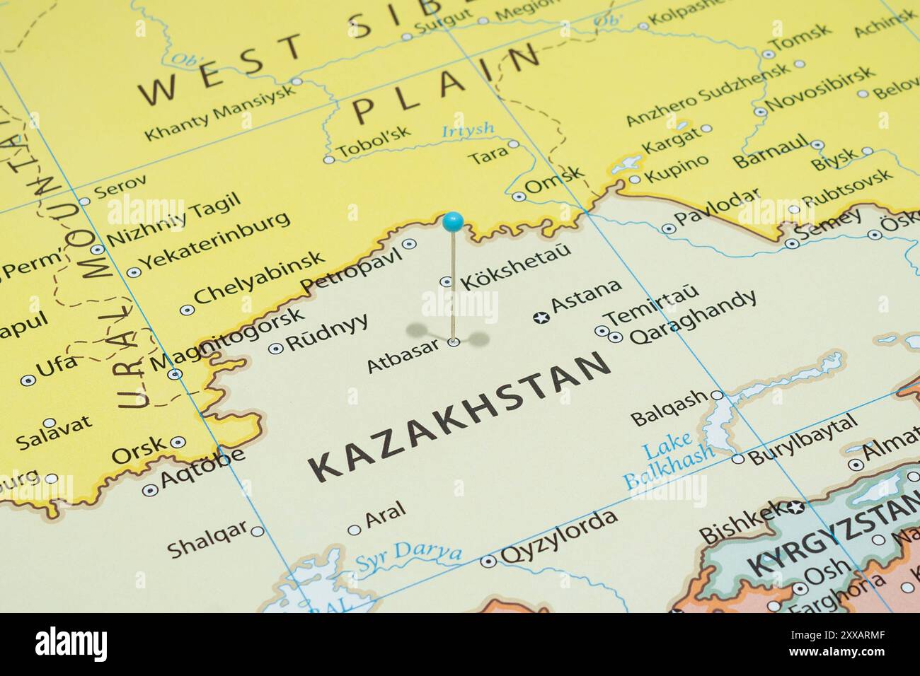 Close up to a Atbasar city with a light blue pin needle into Kazakhstan ...