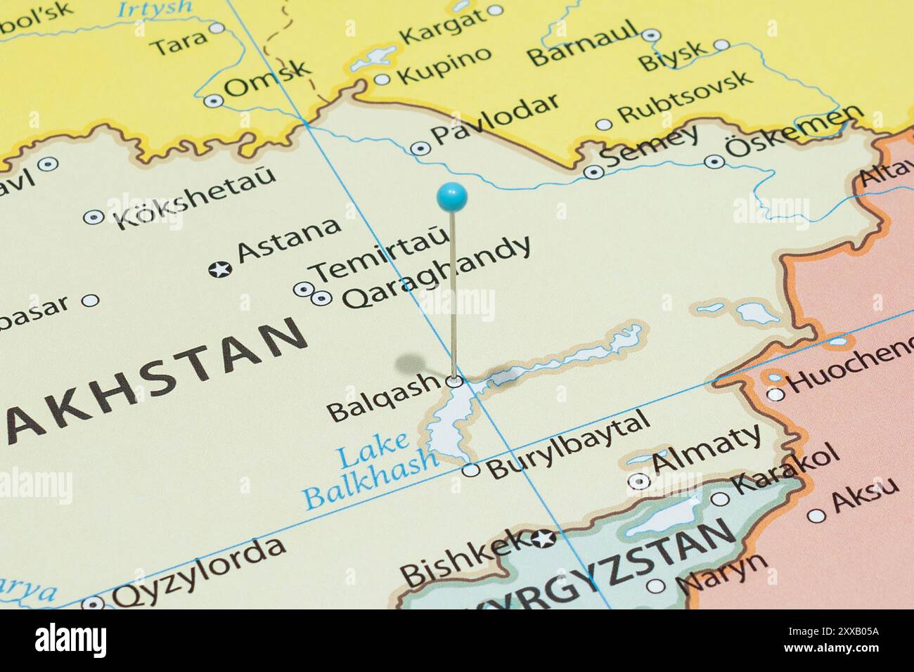 Close up to a Balkhash city with a light blue pin needle into ...