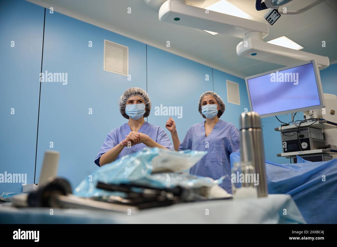 Medical team performing surgical operation in modern operating room ...