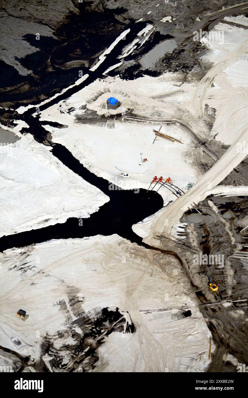 Detail from one of the enormous tailings ponds in Fort McMurray in Alberta, Canada. The ponds are among the largest man made structures in the world, spanning more than 175 square kilometres. They pose an added challenge to the oil sands production: even after ended production, it can take up to 30 years for the silt in the ponds to dry up. The contaminated water is toxic to any living creatures. The Athabasca oil sands deposit is among the largest in the world.  The bitumen, also commonly named tar (hence tar sands), contains lots of hydrocarbons, but is notoriously hard to extract. For every Stock Photo