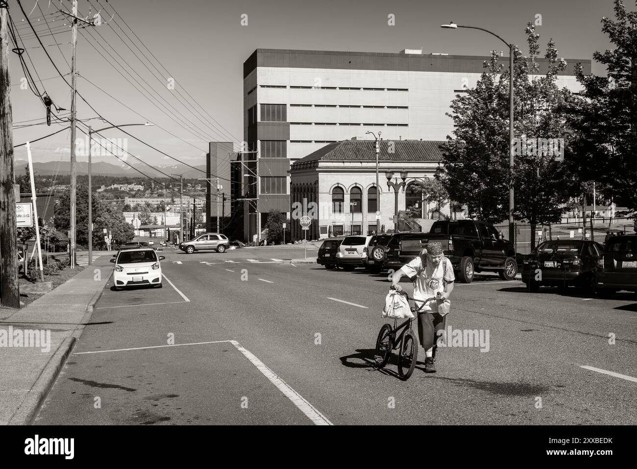 A Homeless man wanders the streets of Everett. With no official campsite and shelters closed due to COVID-19 the homeless are scattered around the city Stock Photo