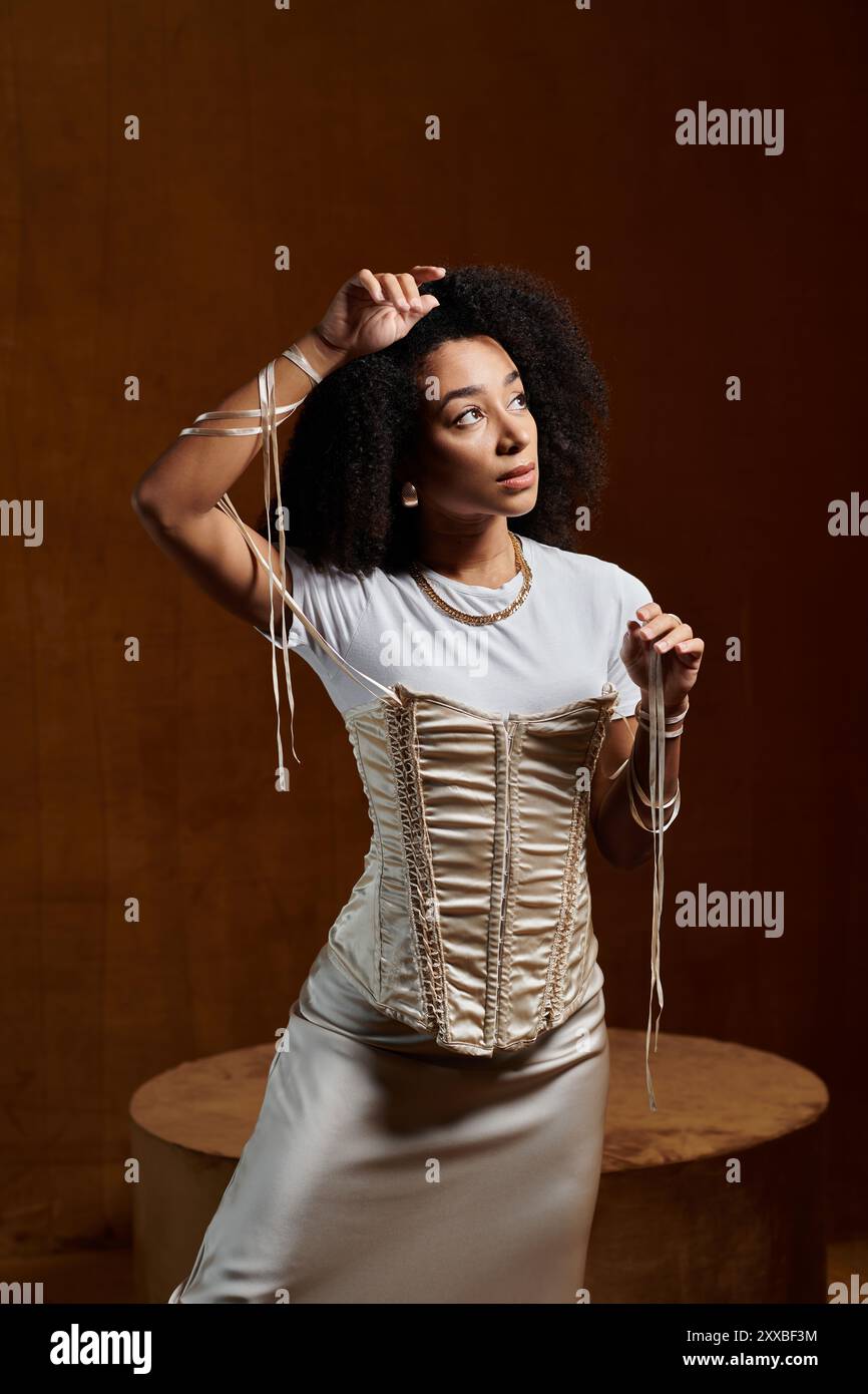 A stylish woman in a trendy outfit poses in a studio setting Stock ...
