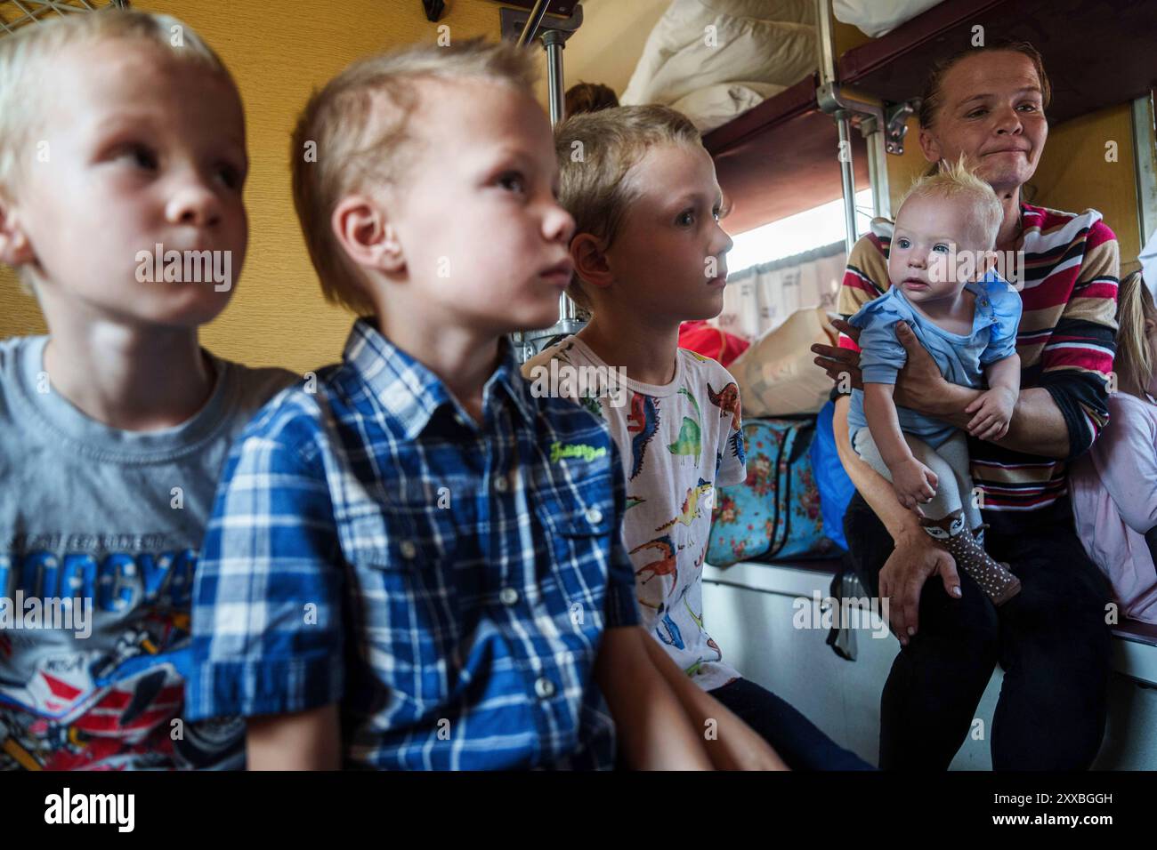 iryna-belikova-37-with-her-children-sit-on-an-evacuation-train-in