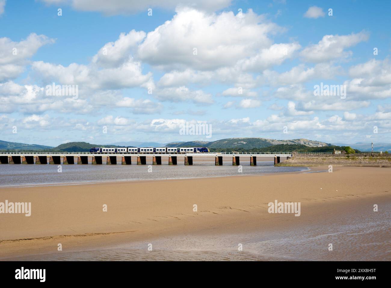A passenger train crosses the Kent railway viaduct, Arnside, Cumbria. Stock Photo