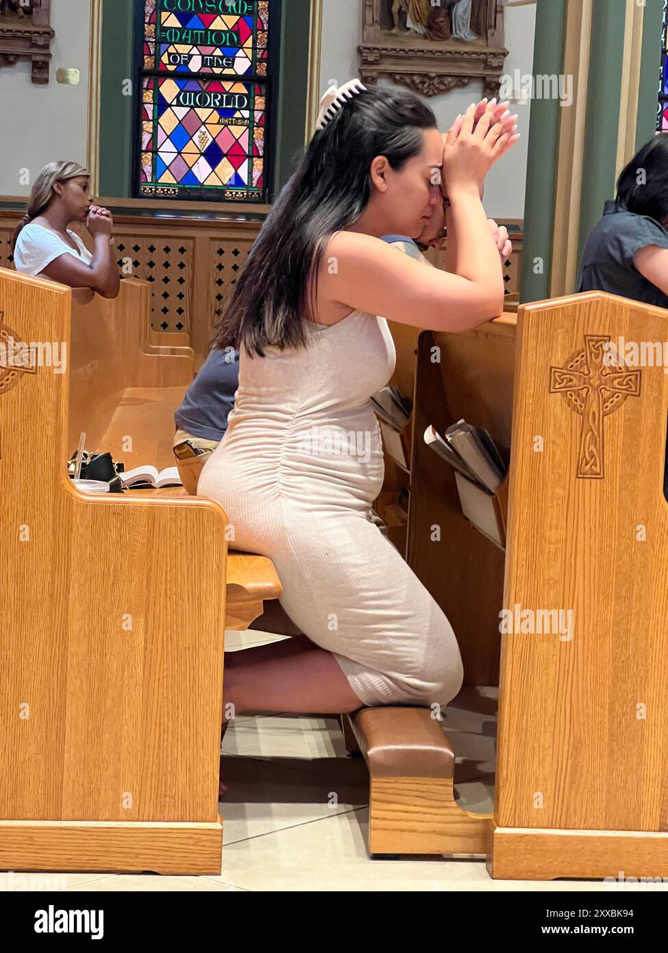 Woman in prayer, Catholic Church, Brooklyn, New York. Stock Photo