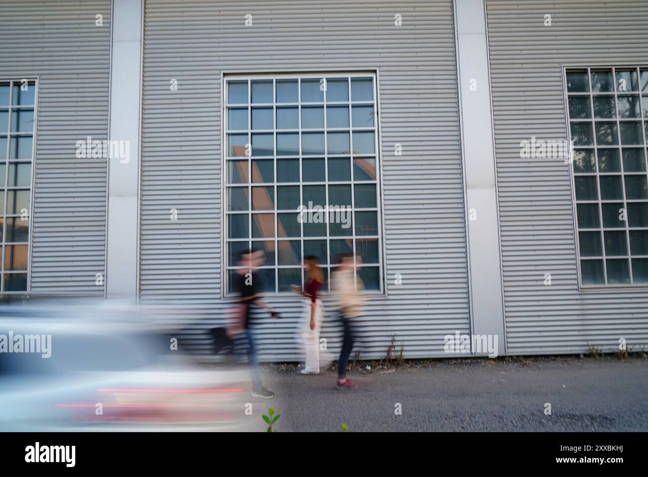A group of people walking down a street with blurred faces Stock Photo ...