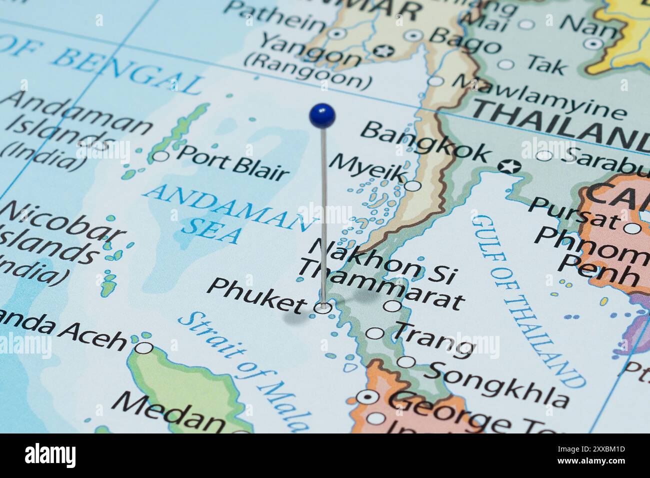 Close up to a Phuket city with a blue pin needle into Thailand country political map Stock Photo