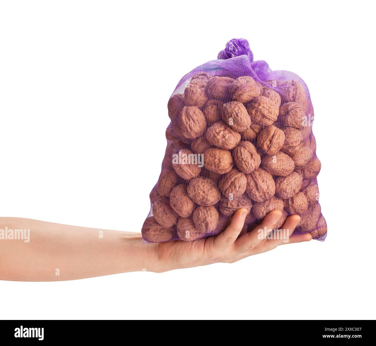 walnuts sack in hand path isolated on white Stock Photo