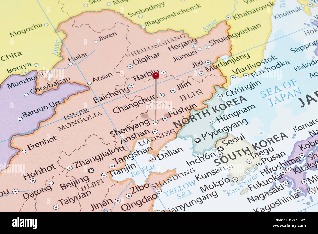 Close up to a Shenyang city with a red pin needle into China country political map Stock Photo