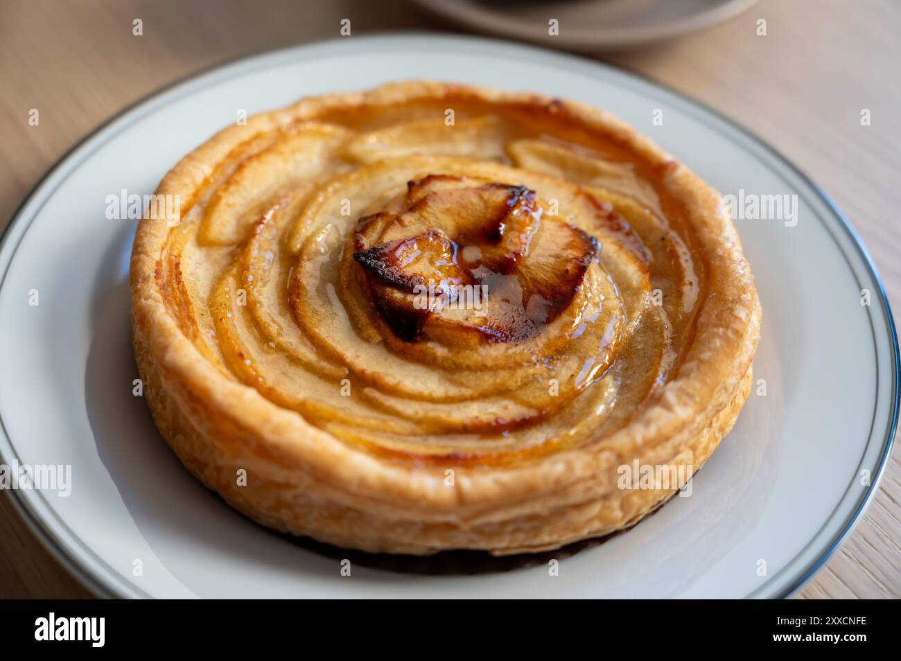 French fresh baked sweet puff pastry with fresh apple fruits in sirup ...