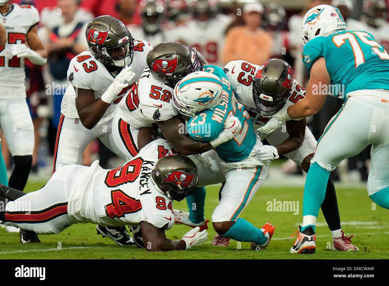 Miami Dolphins running back Jeff Wilson Jr. (23) is stopped short of a