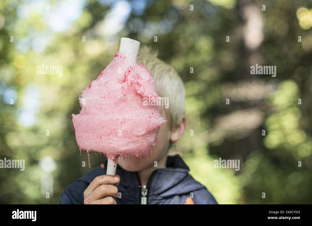 Pink candy floss in front of a kid Stock Photo