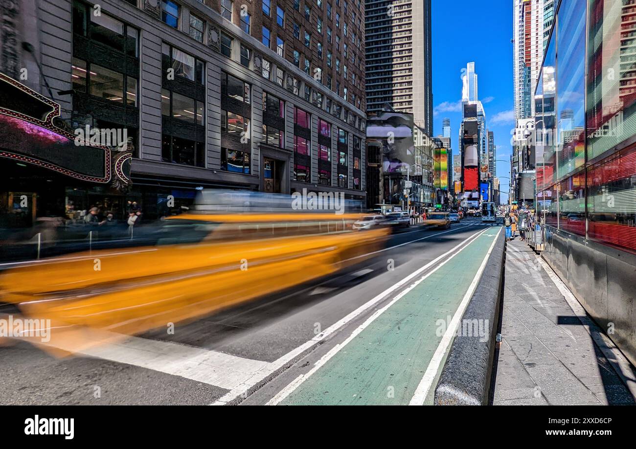 Yellow taxi cab with motion blur effect driving through Times Square in ...