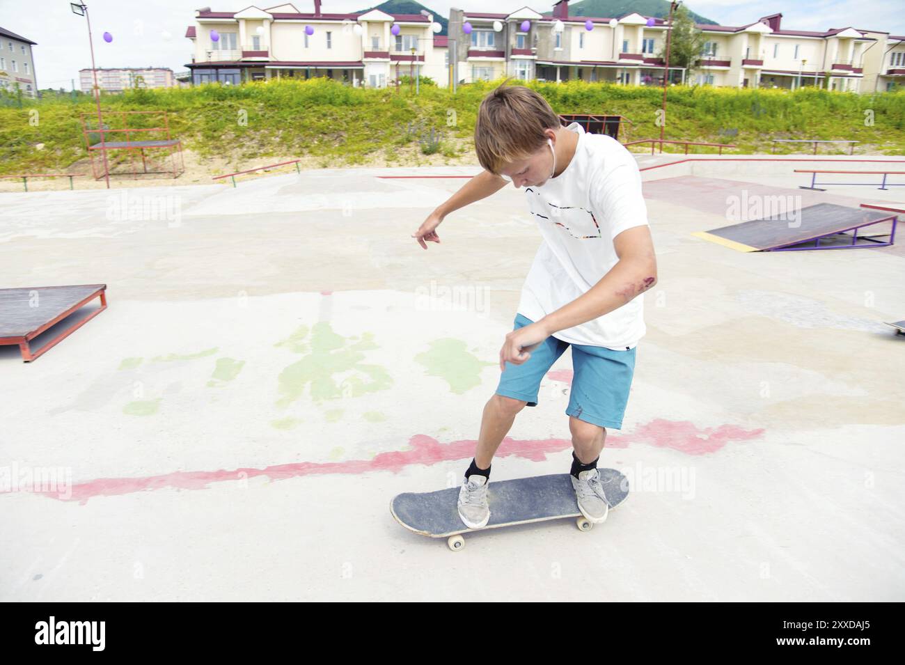 The boy skating catches the balance in the manual and slides on the ...