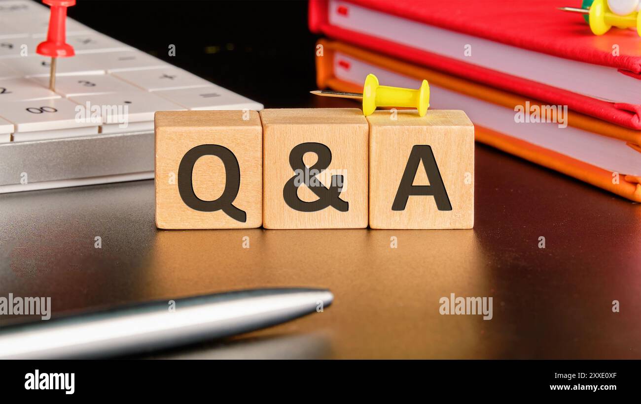 Q and A questions and answers symbol. Concept words Q and A on wooden cubes in front of a black background Stock Photo