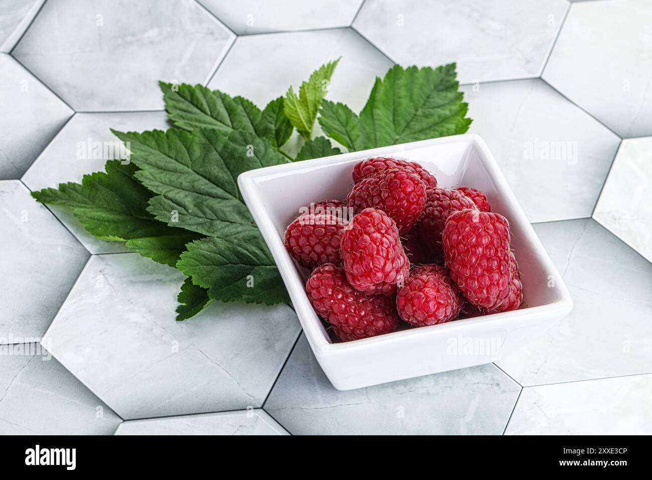 Rope sweet juicy raspberry heap in the bowl Stock Photo - Alamy