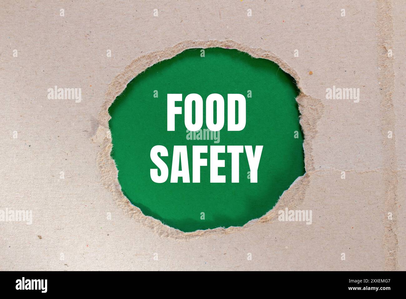 Food safety message written on ripped torn paper with green background ...