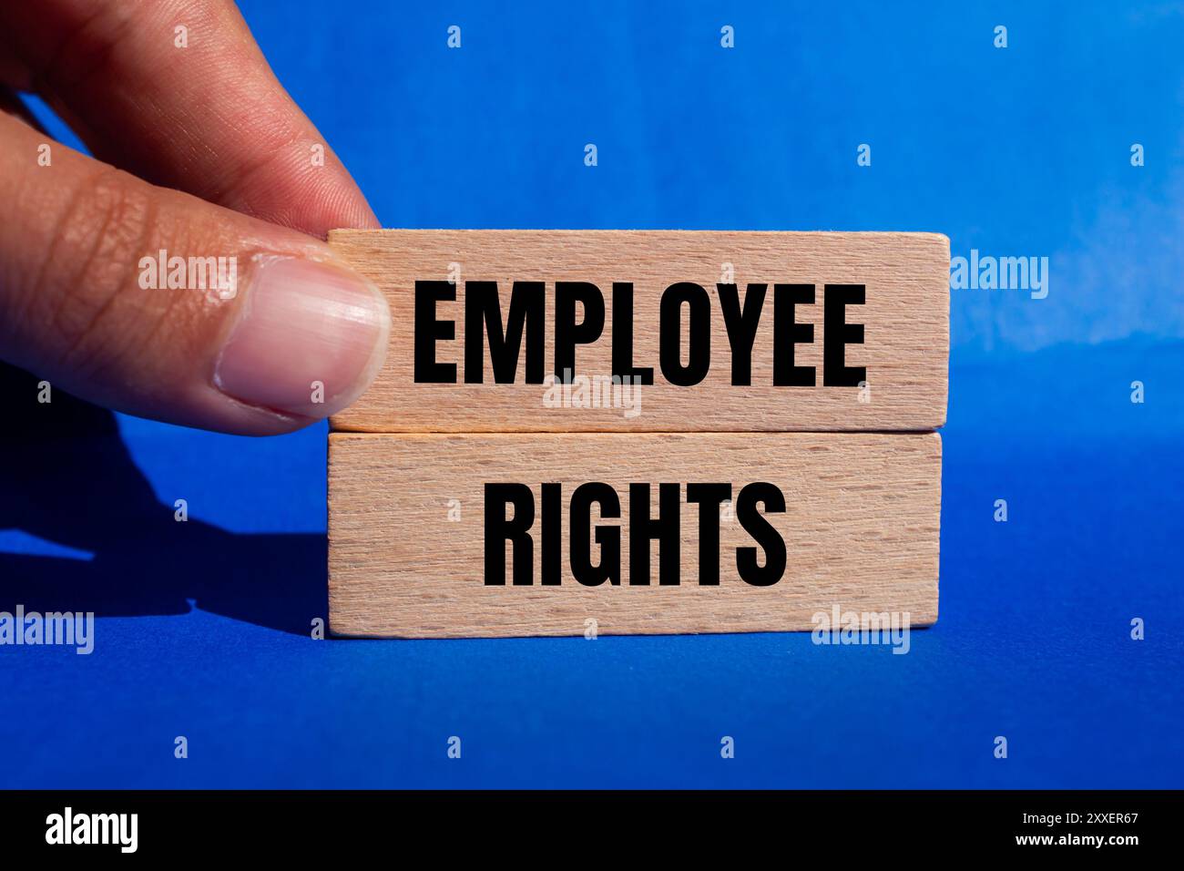 Employee rights message written on wooden blocks with blue background ...