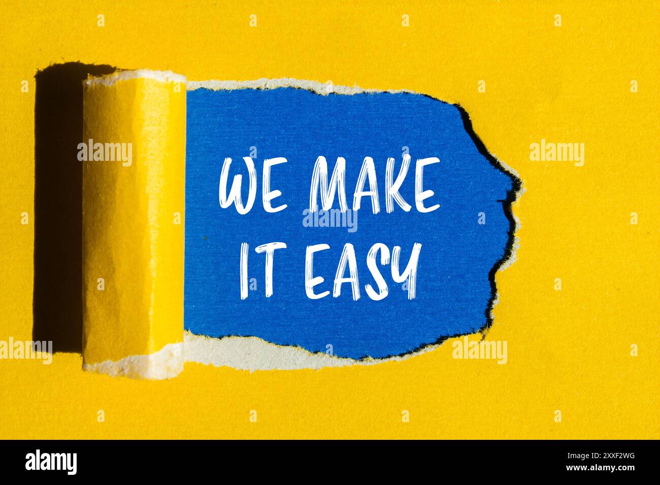 We make it easy message written on ripped yellow paper with blue ...