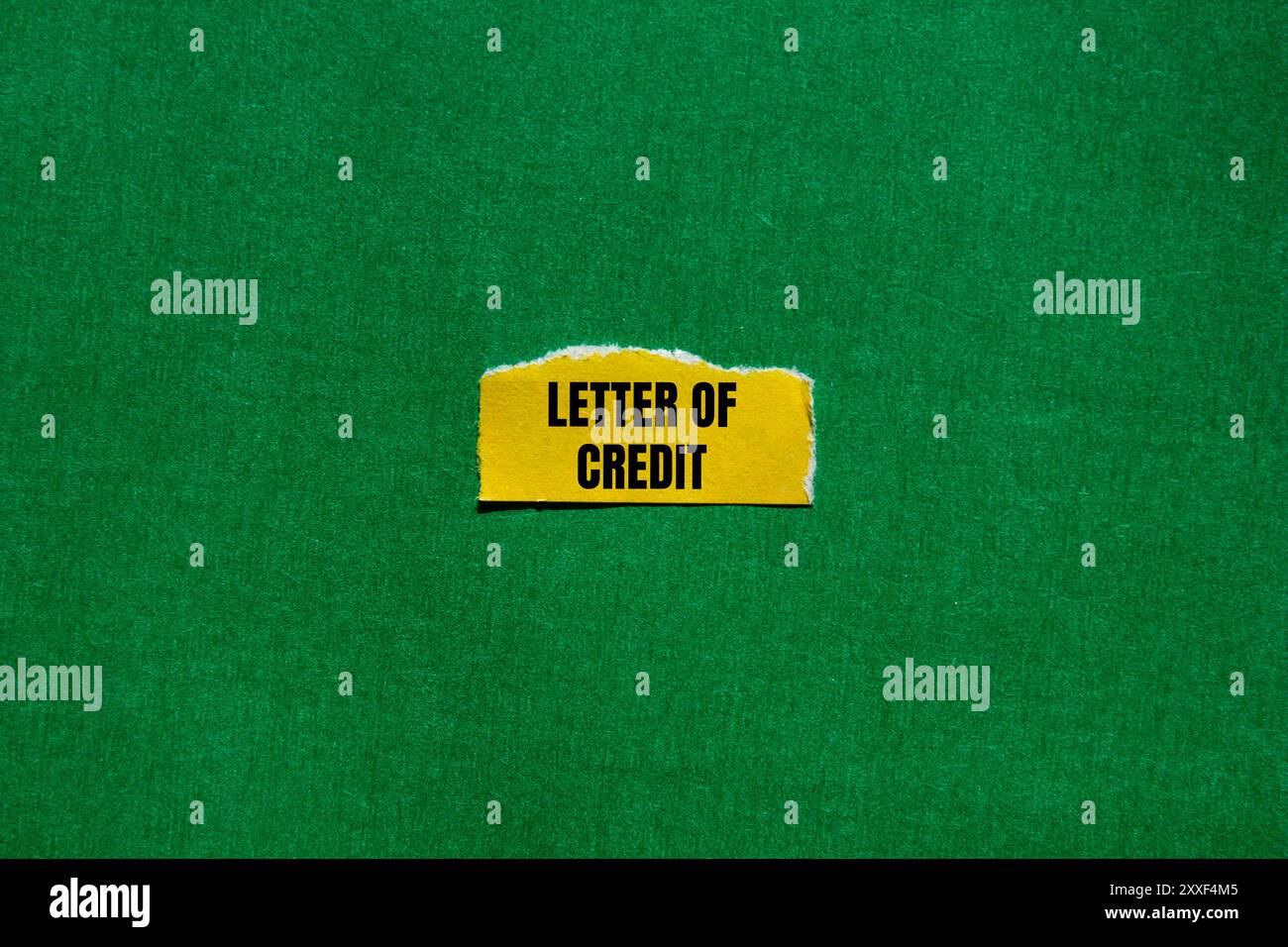 Letter of credit message written on ripped torn yellow paper piece with ...