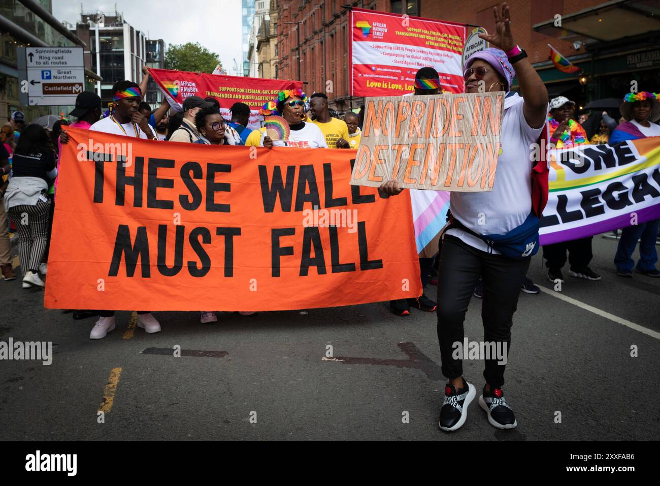 Manchester, UK. 24th Aug, 2024. A Pride attendee holds a placard during the Pride parade. The LGBTQ  community come together for the three day event that sees live music and parties across the city, with the main parade happening on the Saturday. Credit: Andy Barton/Alamy Live News Stock Photo