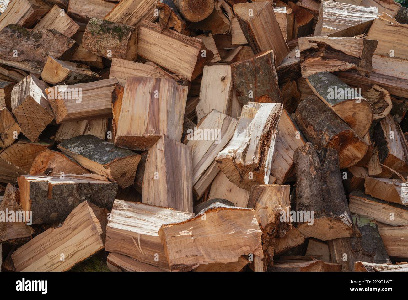 A neat stack of wood planks sits on top of each other, forming a stable arrangement Stock Photo