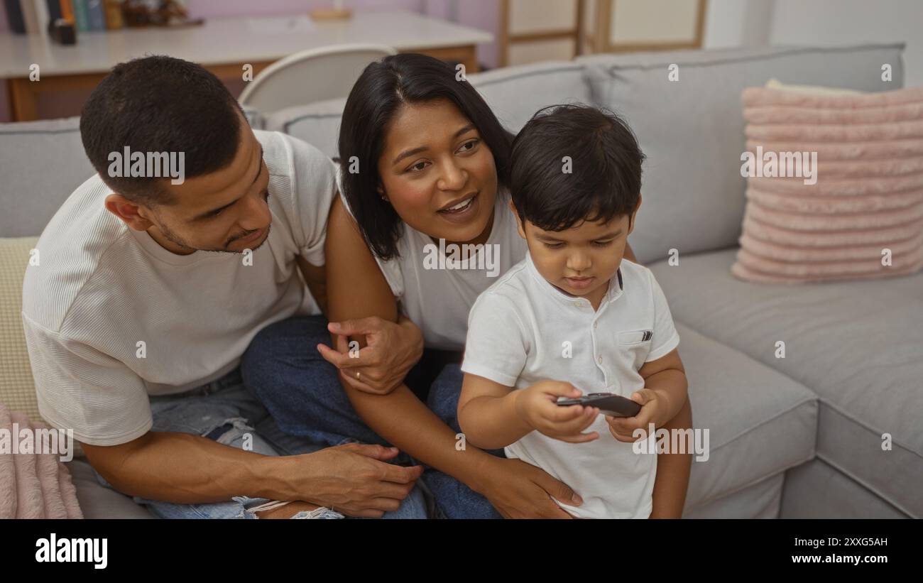 Happy family of man, woman, and child together in a cozy living room at ...