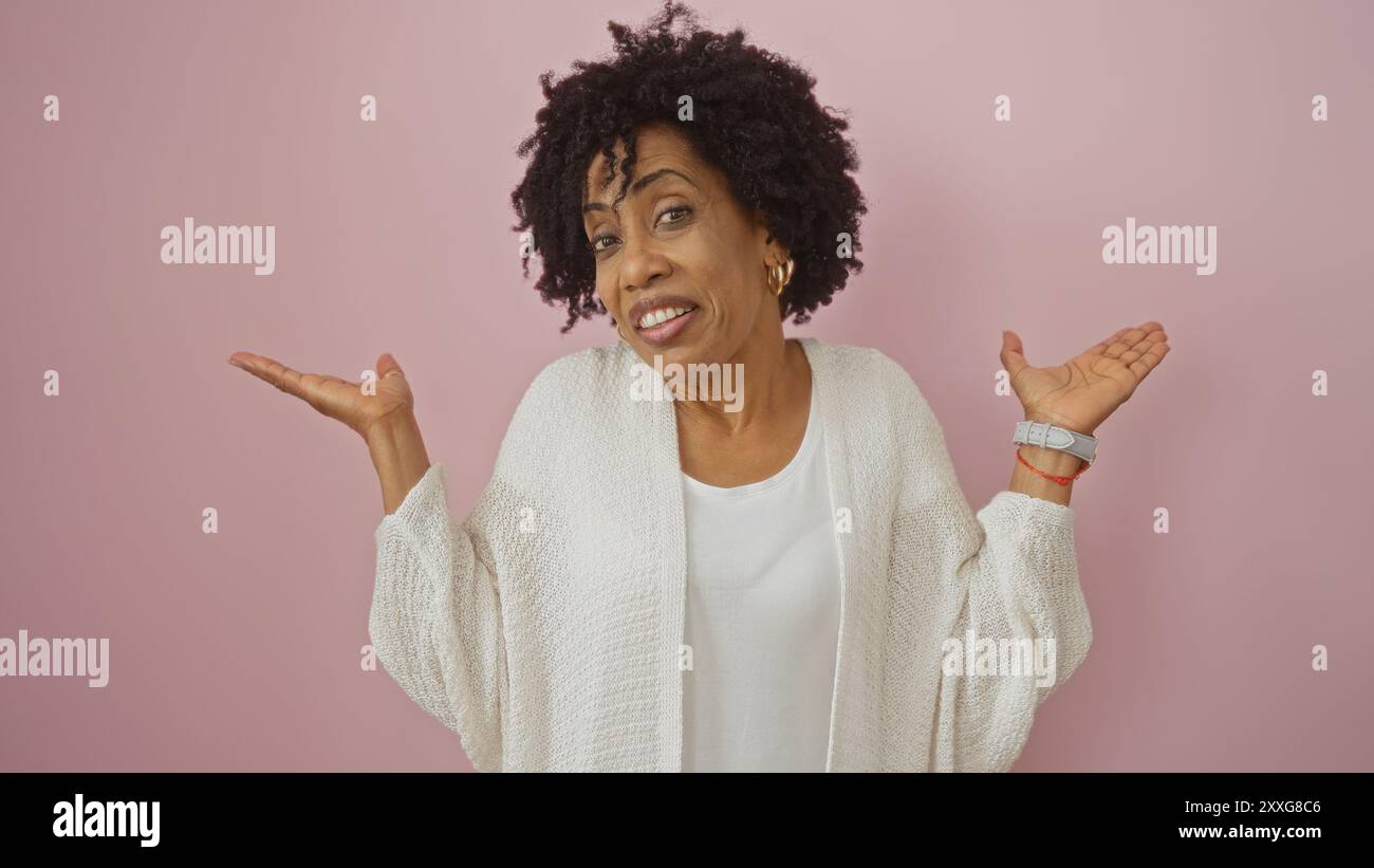 A beautiful young african american woman with curly hair shrugs in a ...