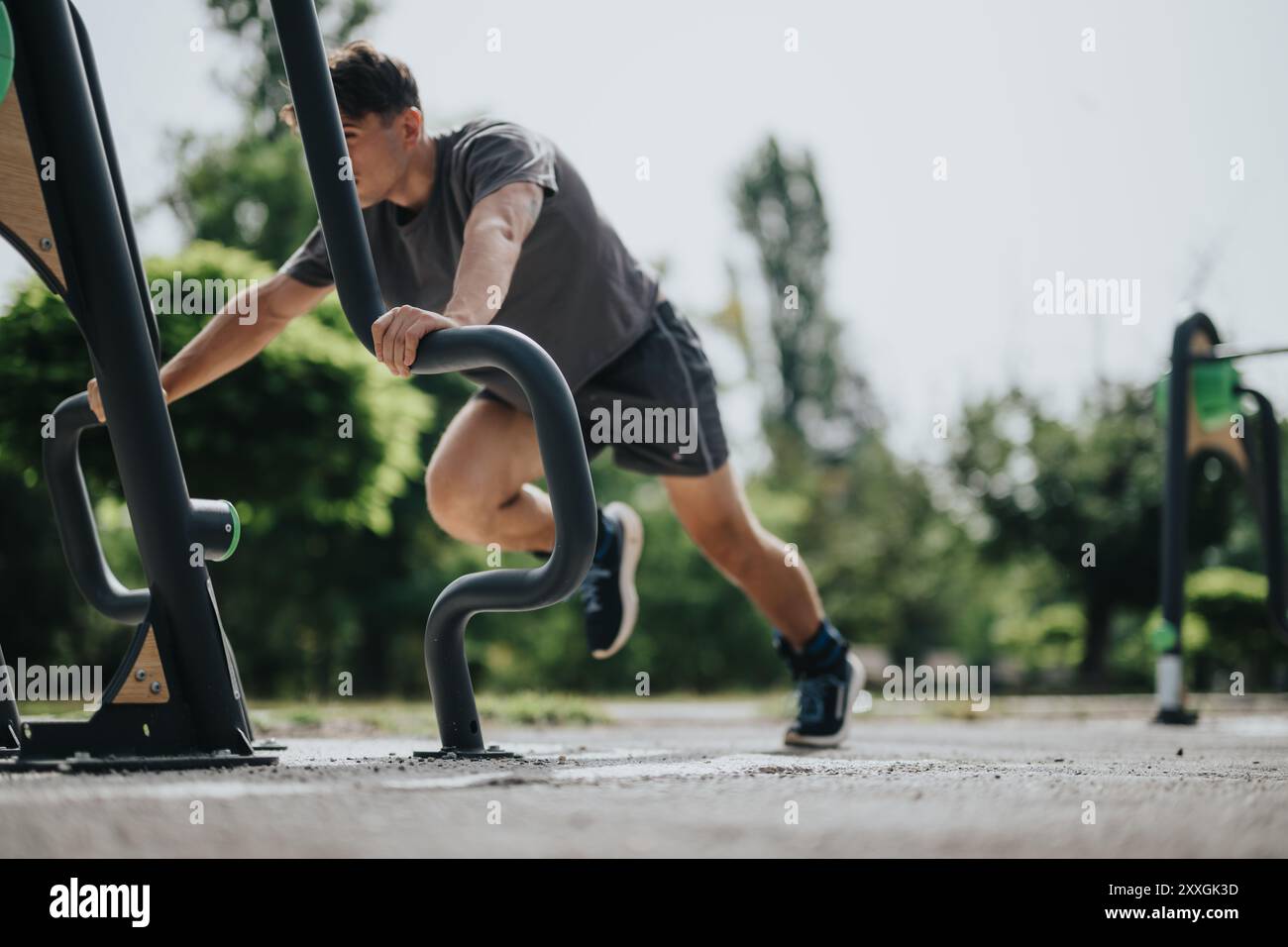 Young man doing outdoor exercise at sports park for fitness and health ...