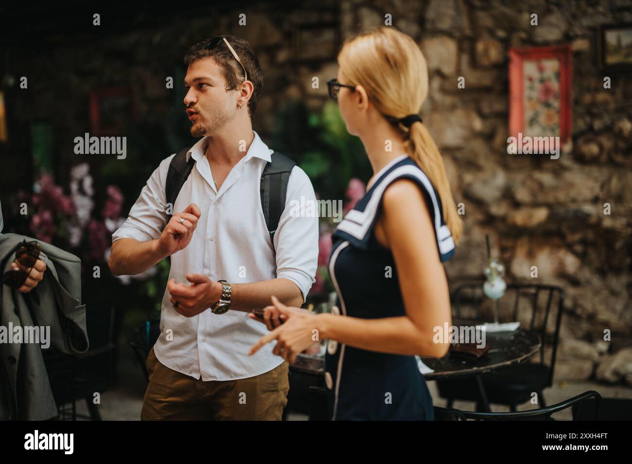 Casual conversation between colleagues in outdoor cafe setting Stock Photo