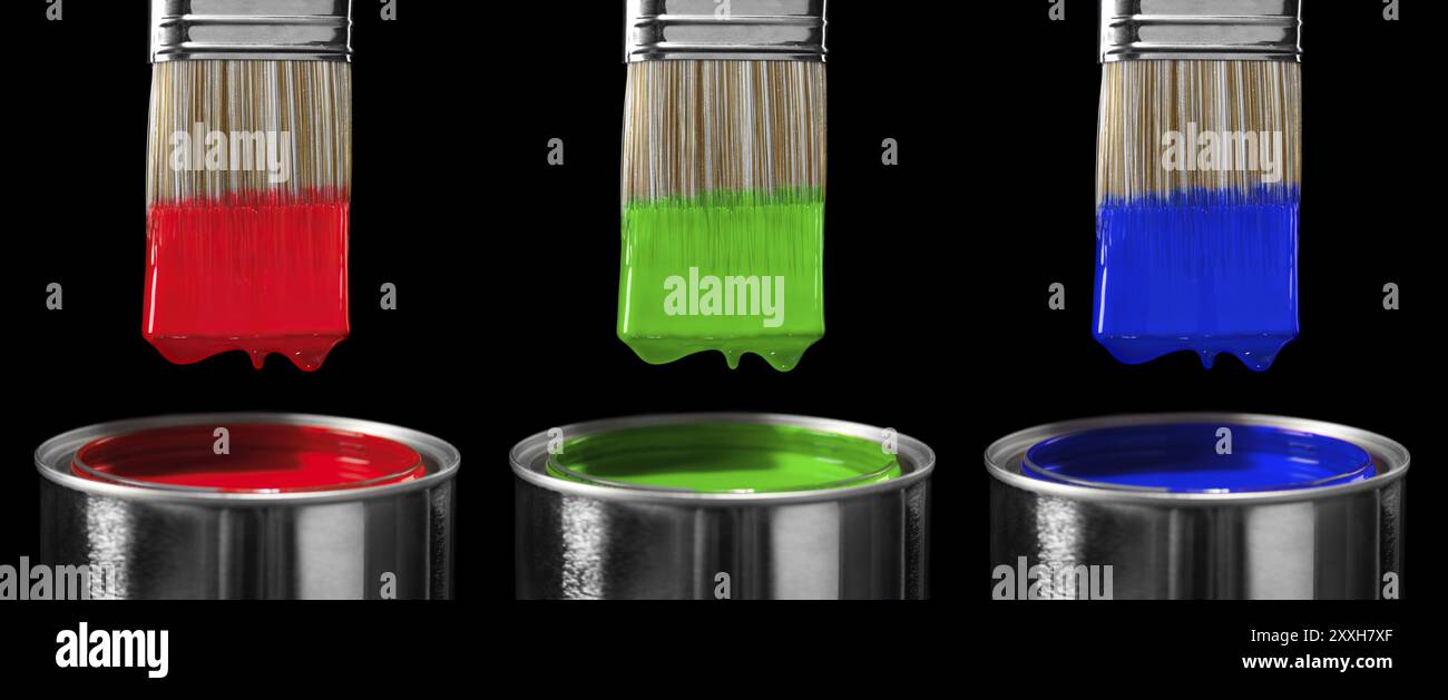Three paint brushes dipped in red green and blue paint isolated on ...