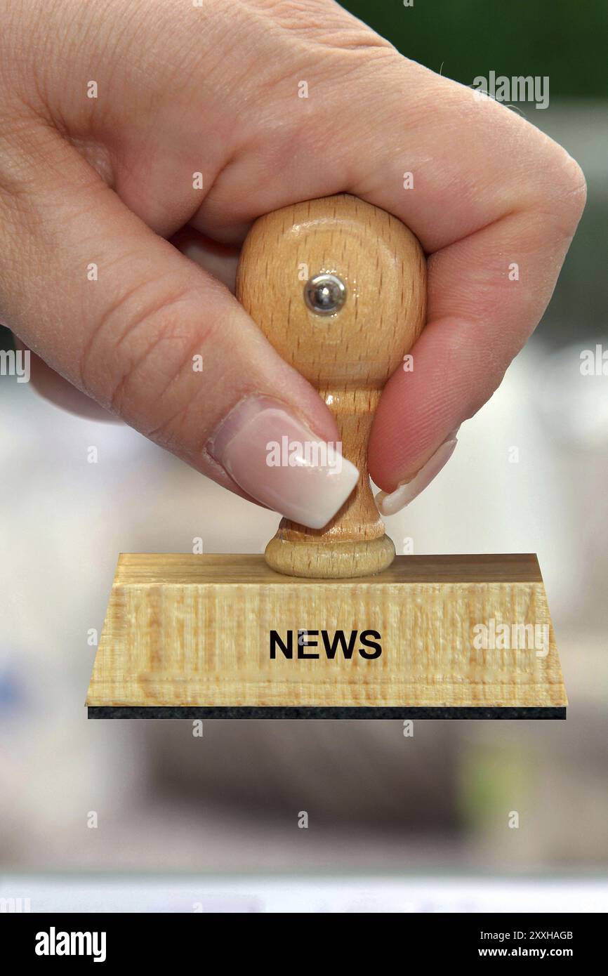 Symbol photo, woman's hand with stamp, inscription: News, Studio Stock ...