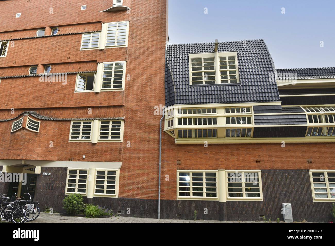 Amsterdam, Netherlands. June 2022. Details and facades of characteristic brick construction of residential building in Amsterdam School style architec Stock Photo