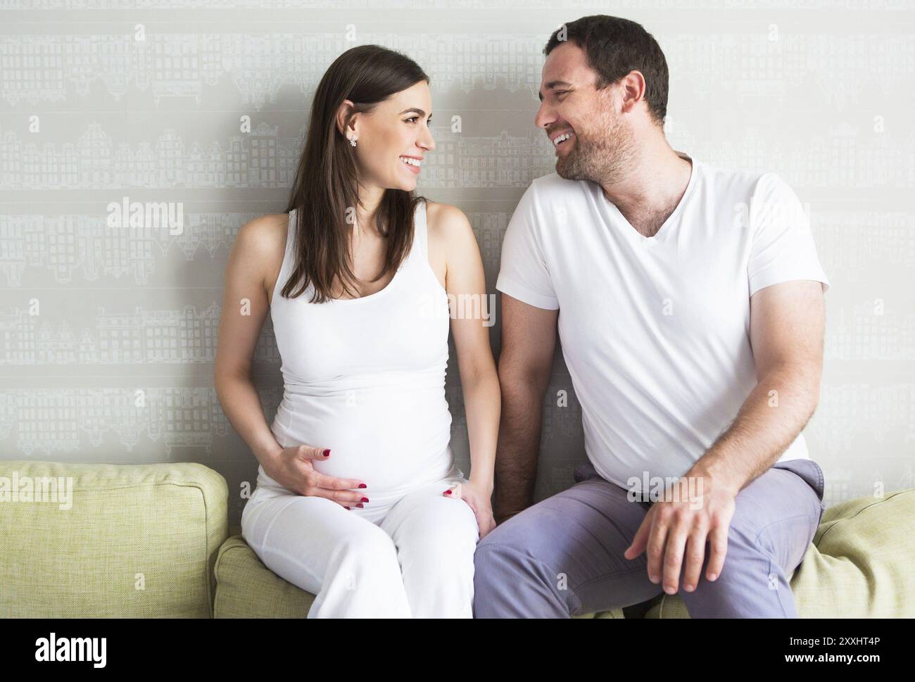 Pregnant woman and young man together indoors Stock Photo - Alamy