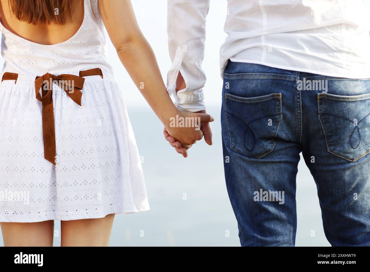 Happy couple in love holding hands walking away near the sea Stock ...