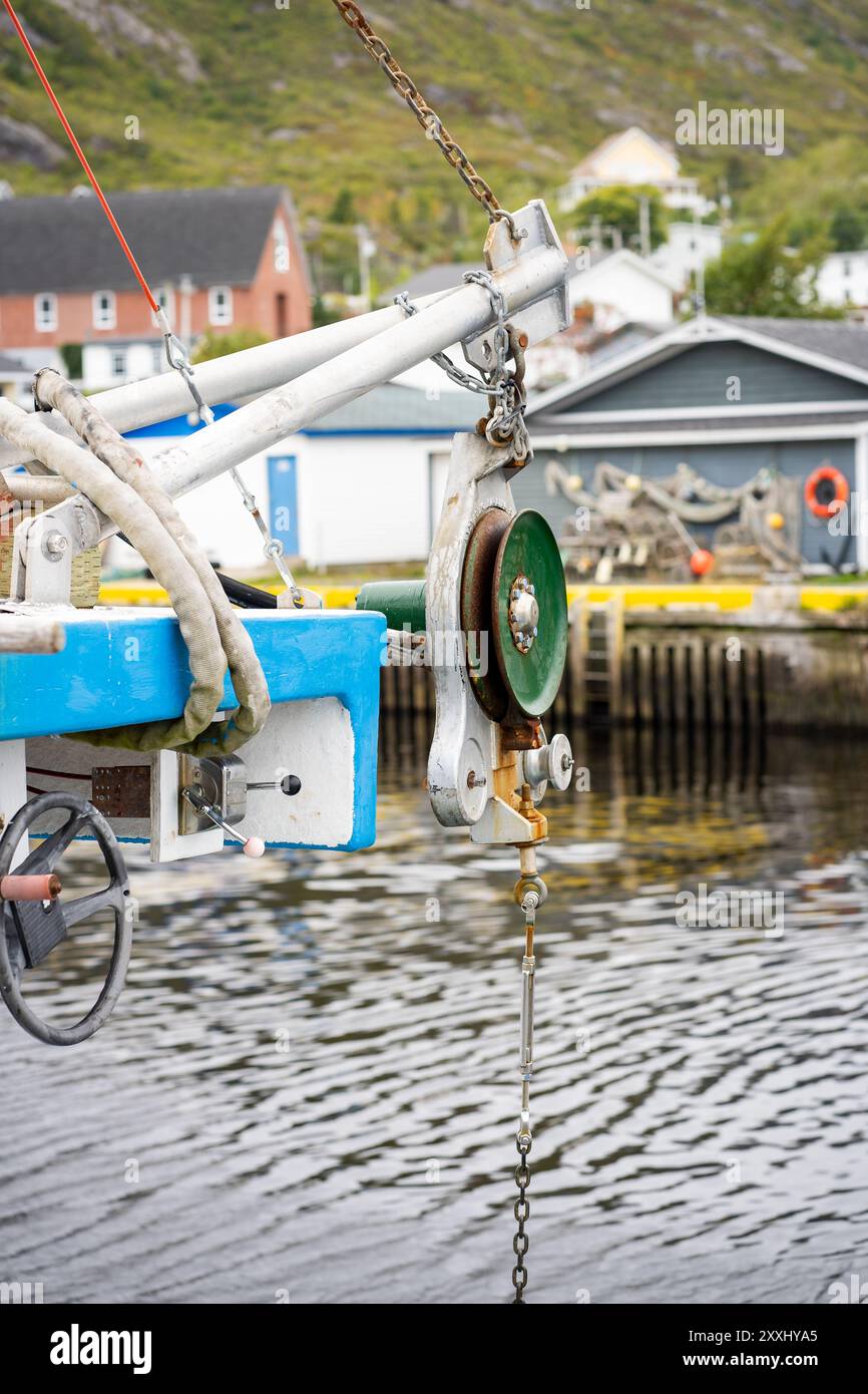 Petty Harbour Newfoundland Canada, September 24 2022: Pulley on a fishing vessel overlooking sheltered harbour along the East Coast of Atlantic Canada Stock Photo