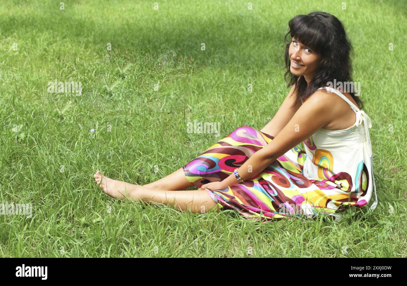 Young smiling brunette woman in summer park Stock Photo