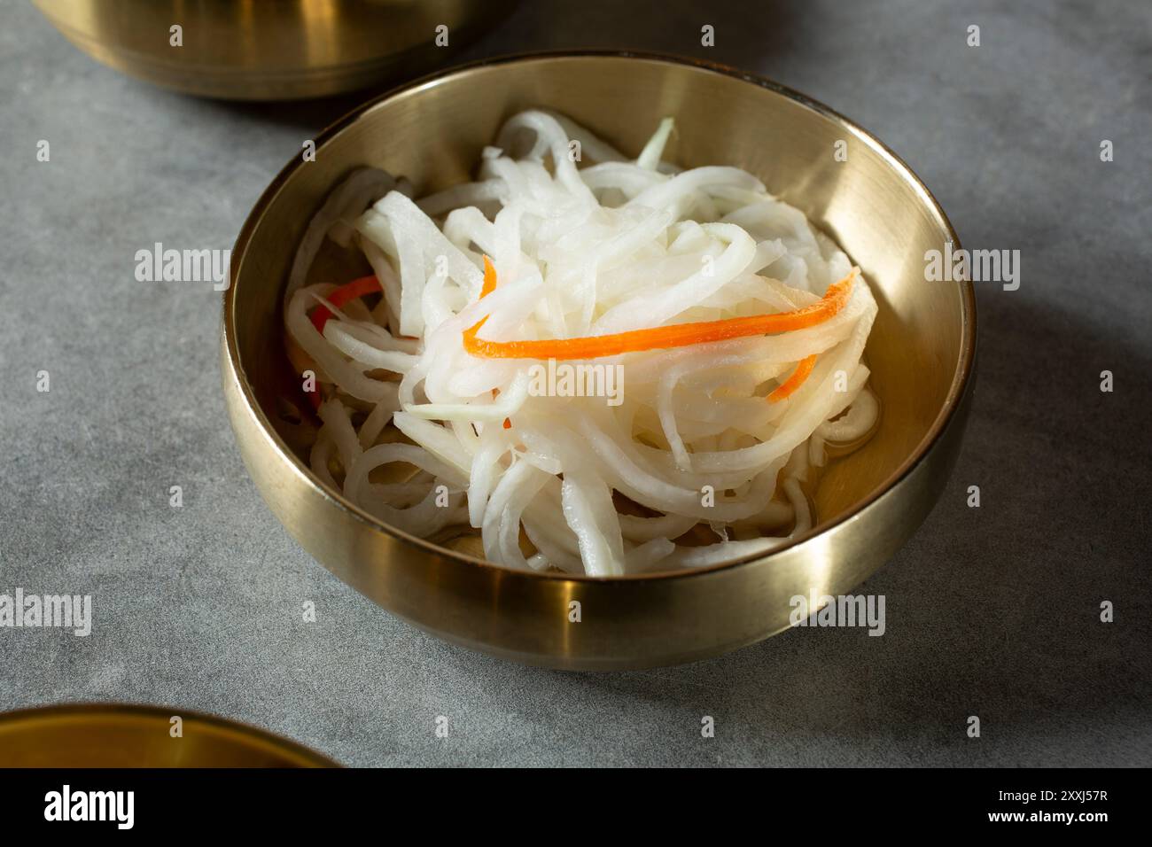 A closeup view of a banchan bowl of pickled daikon radish. Stock Photo