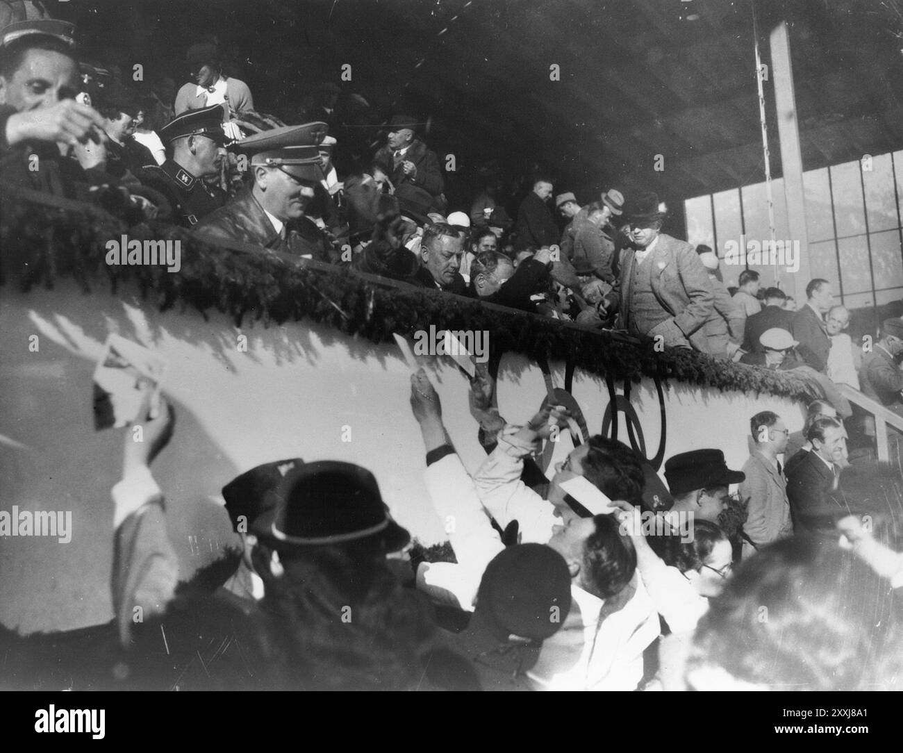 Adolf Hitler and Josef Goebbels sign autographs for members of the Canadian figure skating team at the 1936 Olympics. Stock Photo