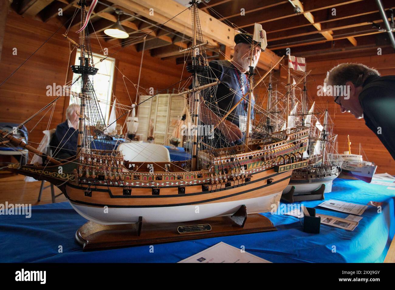 Richmond, Canada. 24th Aug, 2024. People look at model sailboats during the 21st annual Richmond Maritime Festival in Richmond, British Columbia, Canada, Aug. 24, 2024. The two-day event kicked off here on Saturday. Credit: Liang Sen/Xinhua/Alamy Live News Stock Photo