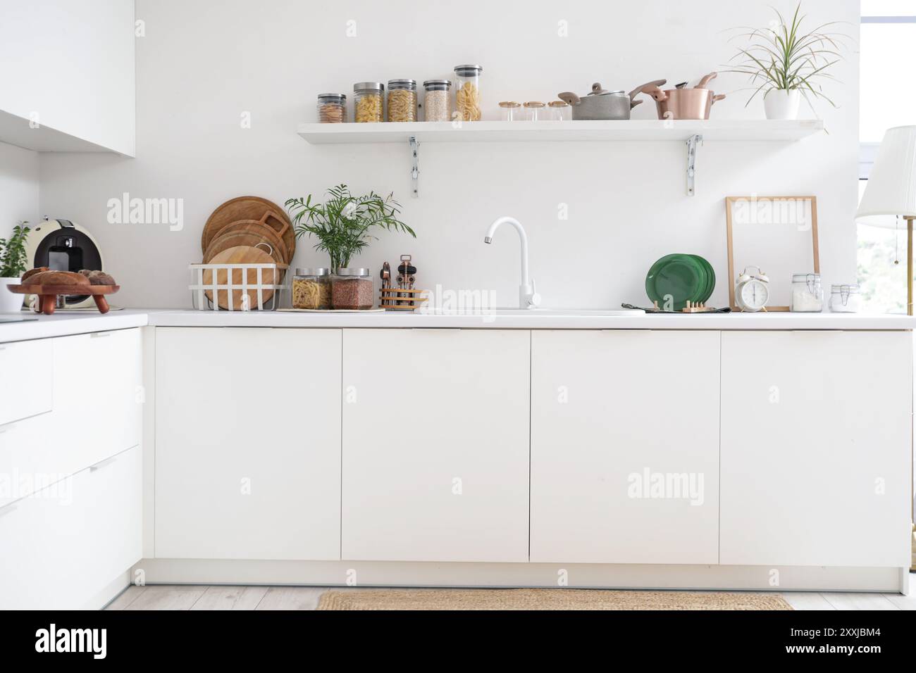 Interior of kitchen with white counters, shelf and utensils Stock Photo ...