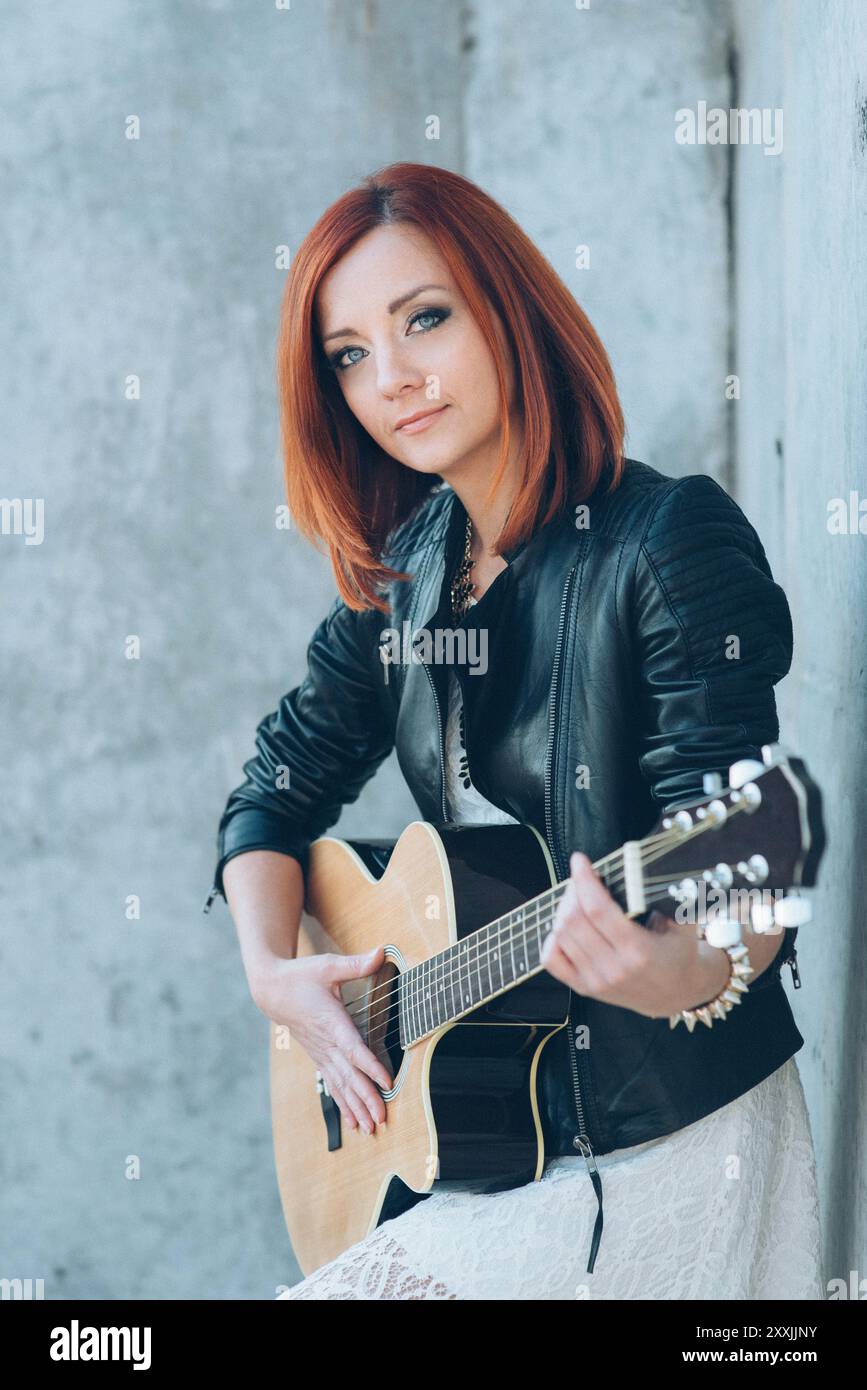musician young girl with red hair with an acoustic guitar Stock Photo ...
