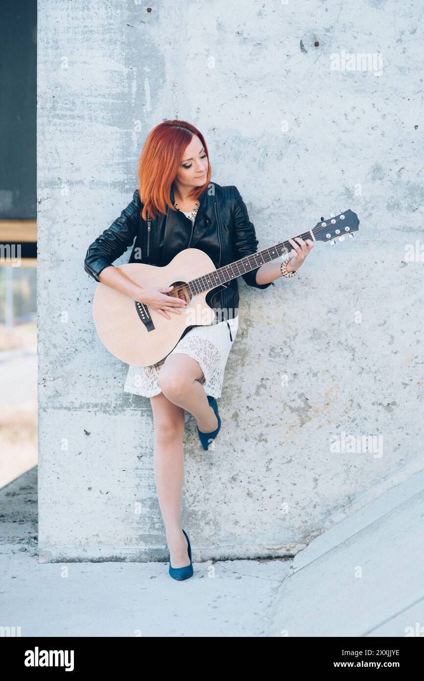 musician young girl with red hair with an acoustic guitar Stock Photo ...