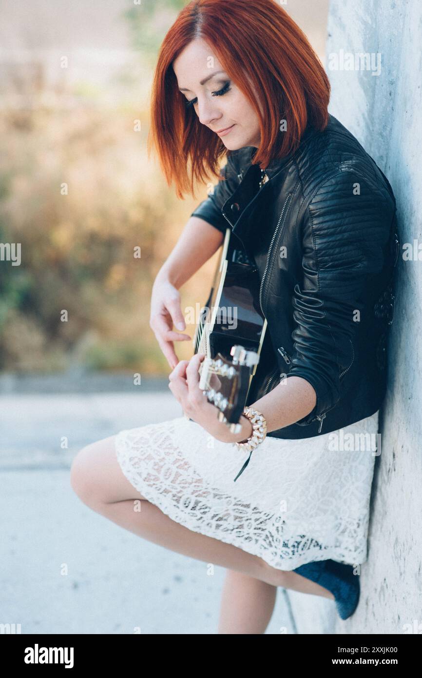 musician young girl with red hair with an acoustic guitar Stock Photo ...